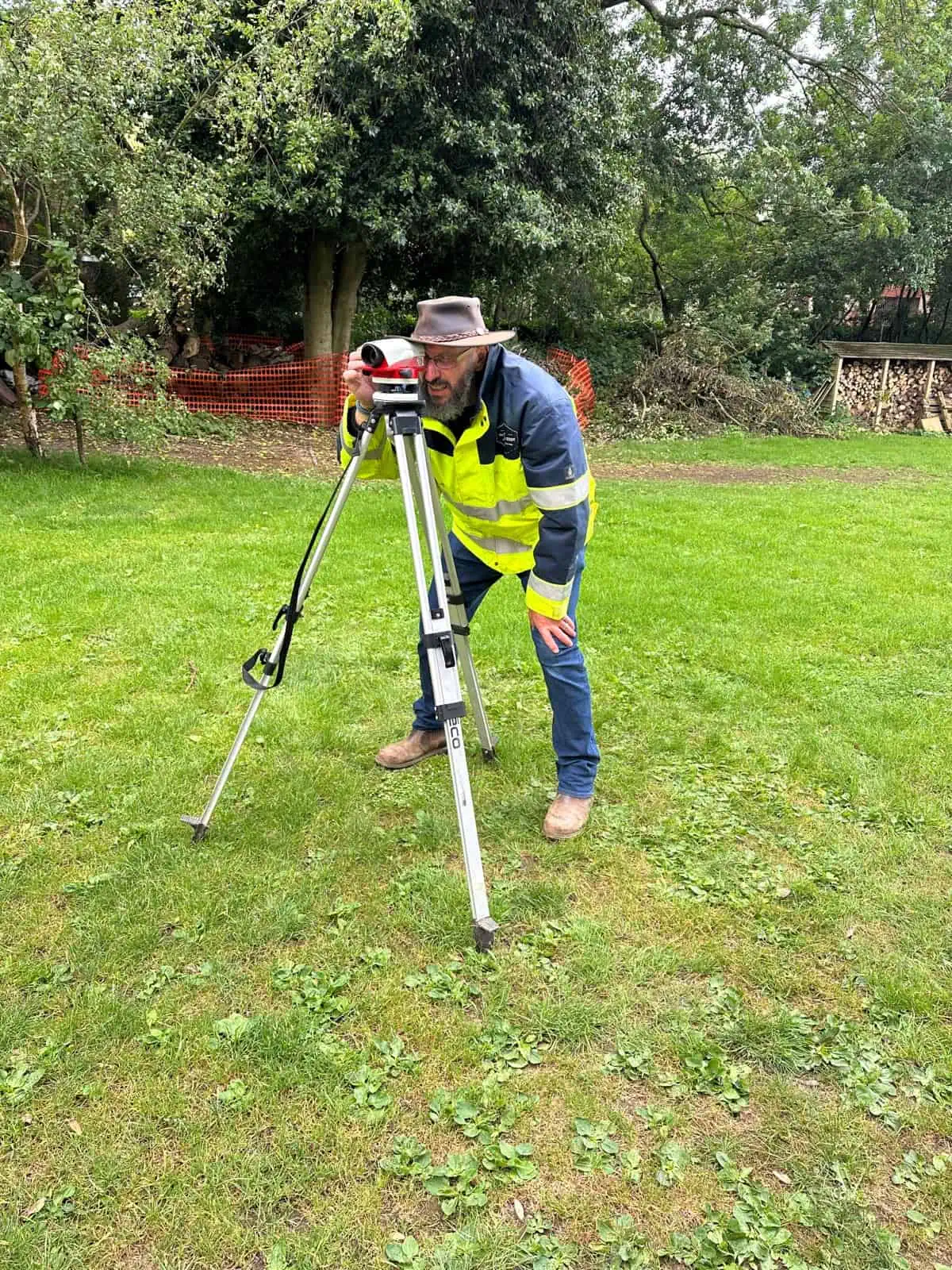 Levelling instrument on a tripod during practical construction levelling training.